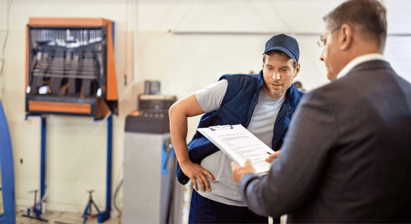 two males looking into equipment rental contract